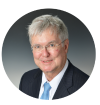 Headshot of Kentucky Farmers Bank SVP/ Trust-Investments. He is smiling, wearing glasses and a suit with a blue tie against a grey background.
